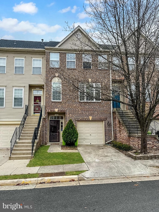 townhome / multi-family property with brick siding, concrete driveway, stairs, and a garage