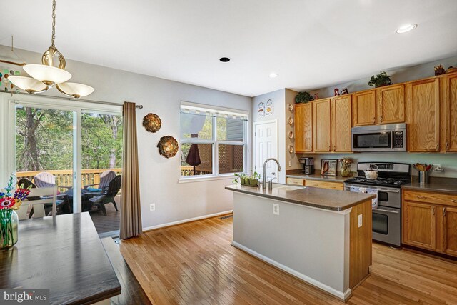 7721 Sullivan Cir, Alexandria, VA 22315 - kitchen featuring dark countertops, appliances with stainless steel finishes, a sink, and a healthy amount of sunlight