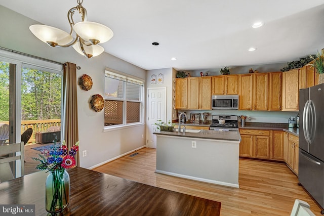 7721 Sullivan Cir, Alexandria, VA 22315 - kitchen featuring a sink, appliances with stainless steel finishes, light wood-style floors, and plenty of natural light