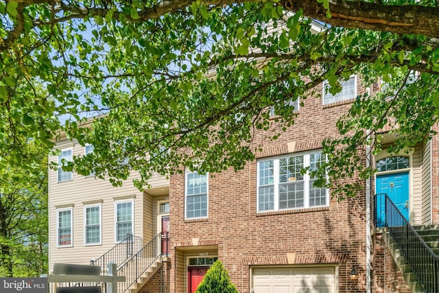 7721 Sullivan Cir, Alexandria, VA 22315 - multi unit property featuring an attached garage, brick siding, and stairs