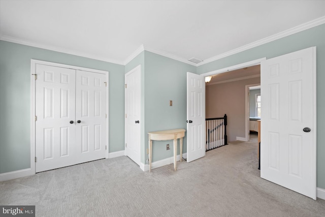 unfurnished bedroom with carpet, baseboards, and ornamental molding