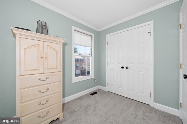 bedroom with crown molding, baseboards, a closet, and light carpet