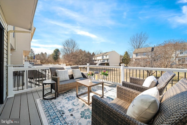 wooden deck with a residential view and outdoor lounge area