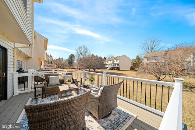 deck featuring a residential view, outdoor lounge area, and a yard