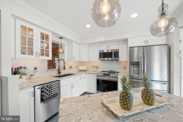 kitchen with a sink, light stone counters, appliances with stainless steel finishes, white cabinets, and glass insert cabinets