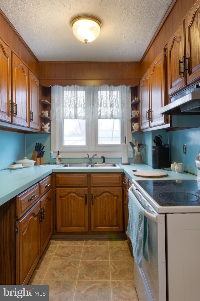 kitchen with open shelves, a sink, brown cabinetry, and white range with electric stovetop