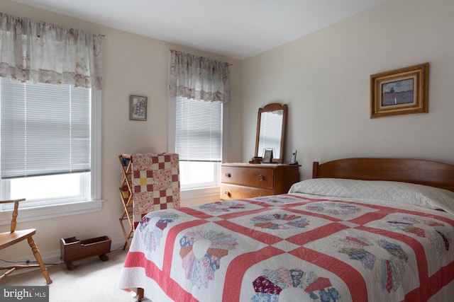 carpeted bedroom featuring multiple windows