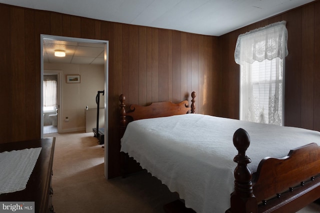 bedroom featuring wooden walls and carpet floors