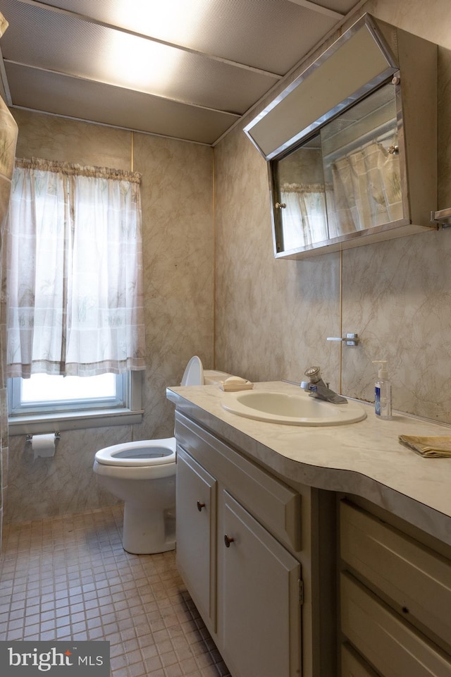 bathroom with tile patterned floors, toilet, and vanity