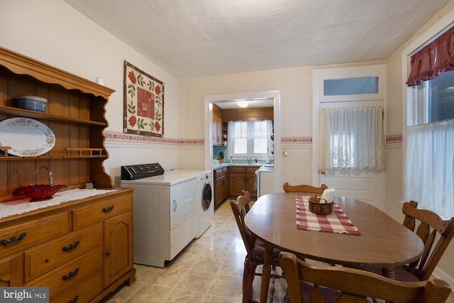 interior space featuring a textured ceiling and washer and clothes dryer