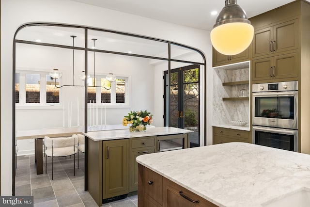 kitchen featuring open shelves, decorative light fixtures, double oven, and a center island