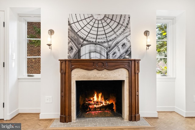 interior details featuring a fireplace with flush hearth and baseboards