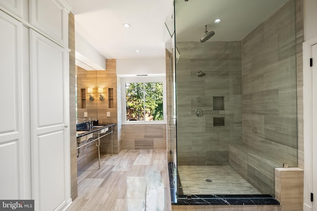 full bathroom featuring a shower stall and a sink