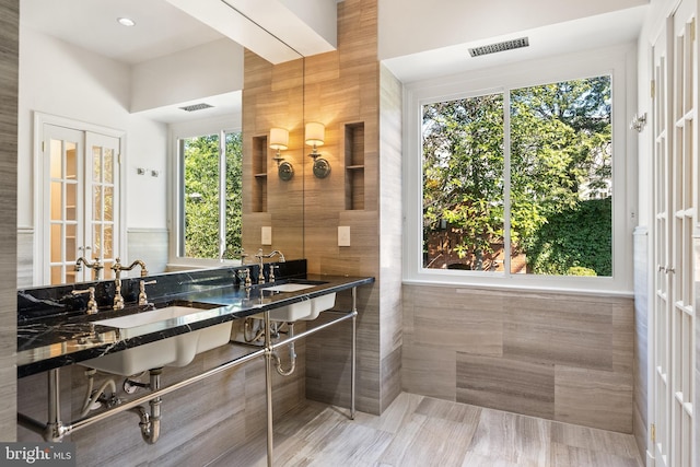 full bathroom featuring visible vents and a sink