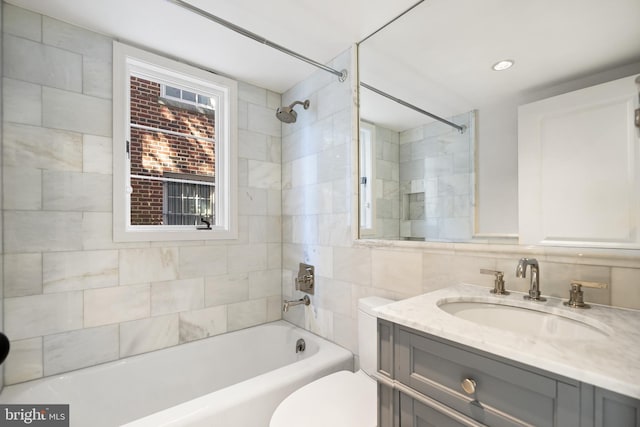 bathroom featuring vanity, shower / bathing tub combination, and toilet