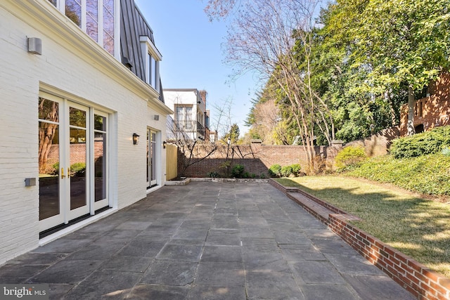 view of patio with french doors and fence