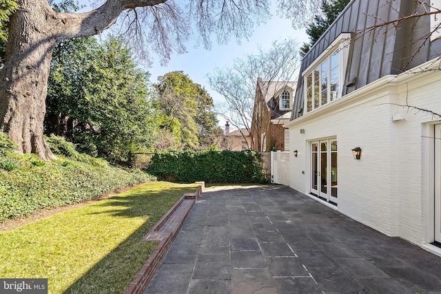 view of patio / terrace with french doors and fence