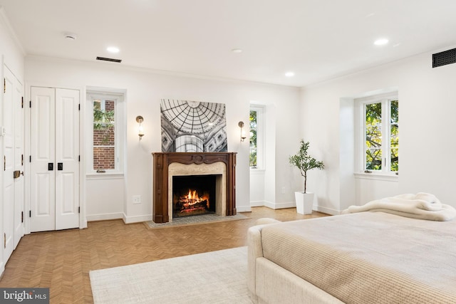 bedroom with recessed lighting, visible vents, baseboards, and a fireplace