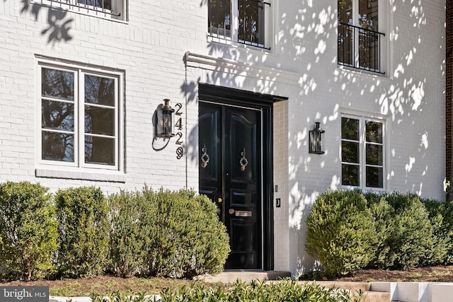 property entrance with brick siding