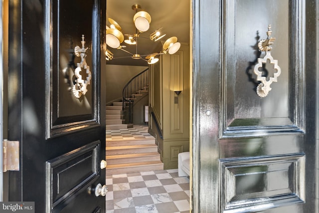 interior space with tile patterned floors, stairway, and a chandelier