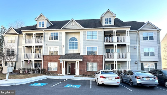 view of building exterior featuring uncovered parking