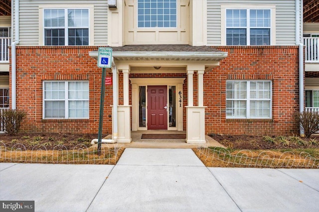 property entrance with brick siding