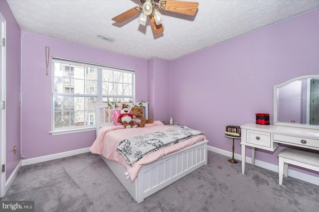 bedroom featuring carpet flooring, baseboards, visible vents, and a textured ceiling