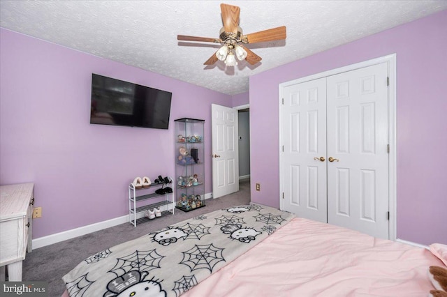 carpeted bedroom featuring ceiling fan, baseboards, a closet, and a textured ceiling