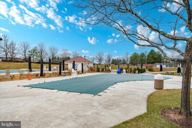 community pool featuring a patio area and fence