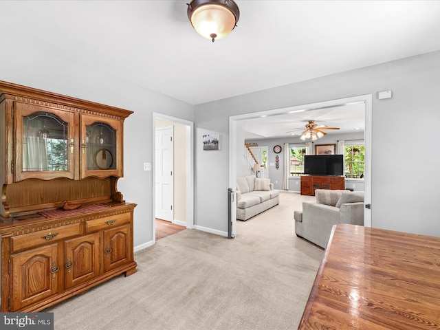 2446 Saint Lukes Rd, Salisbury, MD 21804 - living room with ceiling fan, light carpet, baseboards, and stairs