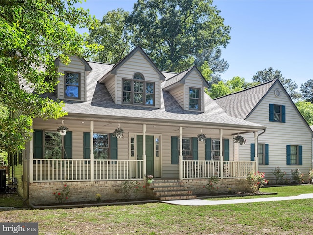 2446 Saint Lukes Rd, Salisbury, MD 21804 - view of front of home with a porch, a shingled roof, and a front lawn
