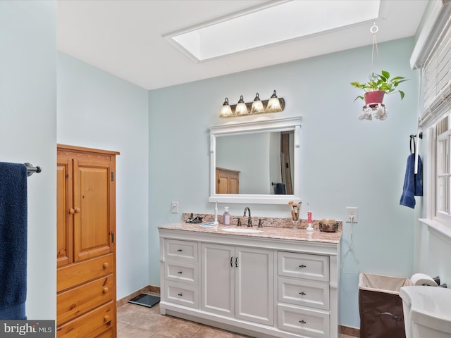 2446 Saint Lukes Rd, Salisbury, MD 21804 - bathroom featuring a skylight, vanity, tile patterned floors, and baseboards