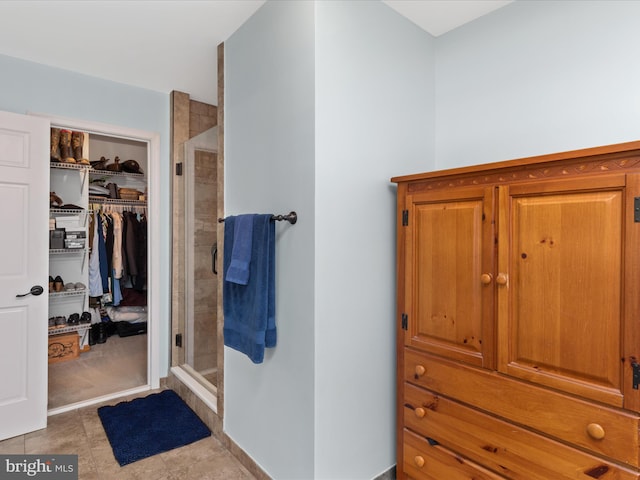 2446 Saint Lukes Rd, Salisbury, MD 21804 - bathroom featuring a shower stall, a spacious closet, and tile patterned flooring