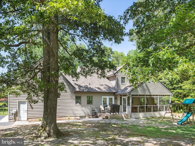 2446 Saint Lukes Rd, Salisbury, MD 21804 - rear view of property with a sunroom, a playground, and roof with shingles