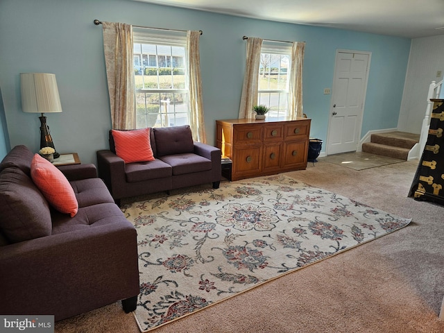 living room with light colored carpet and stairs