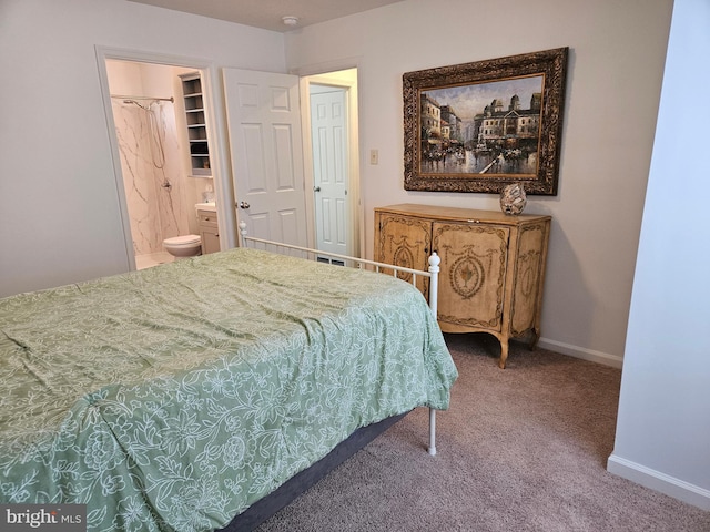 carpeted bedroom featuring baseboards and ensuite bathroom