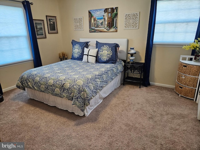 carpeted bedroom with multiple windows and baseboards