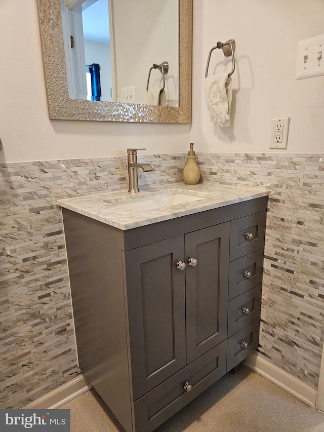 bathroom featuring vanity, tile walls, and wainscoting