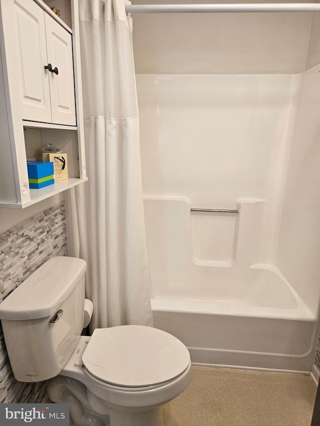 bathroom featuring backsplash, shower / bath combination with curtain, and toilet