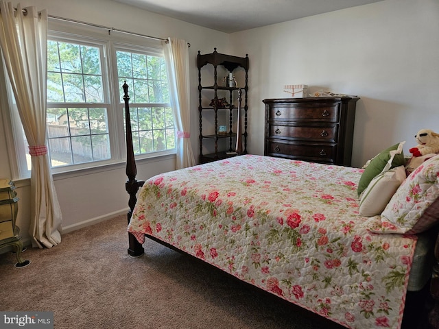 carpeted bedroom featuring baseboards