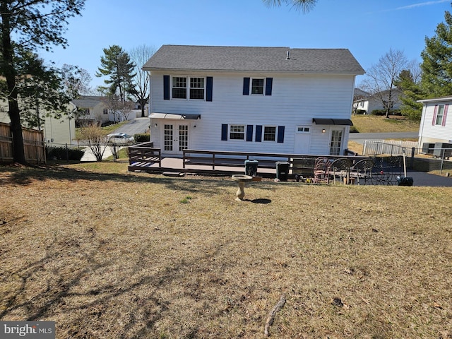 rear view of property featuring a patio, french doors, a yard, and fence