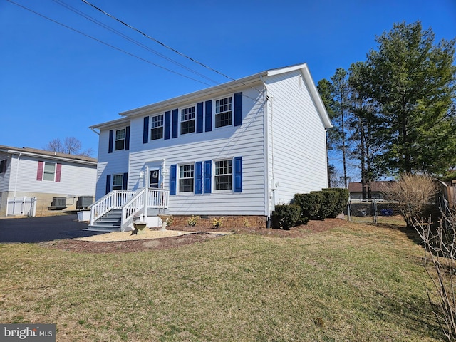 colonial inspired home with a front yard, cooling unit, fence, and crawl space