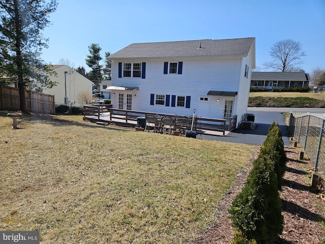 rear view of house with french doors, a yard, a fenced backyard, and a patio area