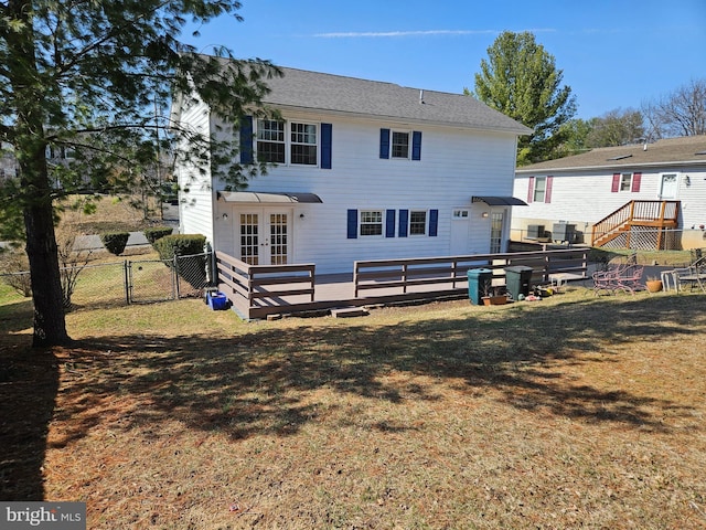 back of house with french doors, fence, a yard, and a gate