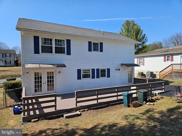 back of property featuring central air condition unit, french doors, a wooden deck, and fence