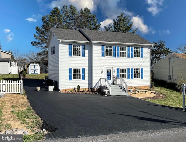 103 Fenwick Ct, Winchester, VA 22602 - view of front of property featuring an outdoor structure, a storage shed, aphalt driveway, and fence