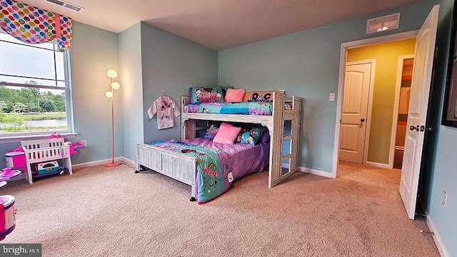 carpeted bedroom featuring visible vents and baseboards