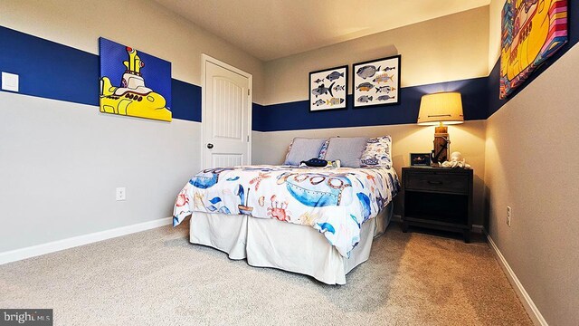 bedroom featuring carpet and baseboards