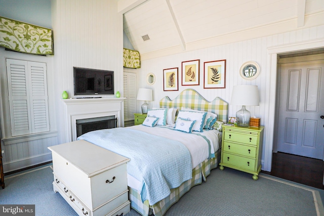 1 103rd St, Stone Harbor, NJ 08247 - bedroom featuring vaulted ceiling with beams, a fireplace, visible vents, and dark carpet