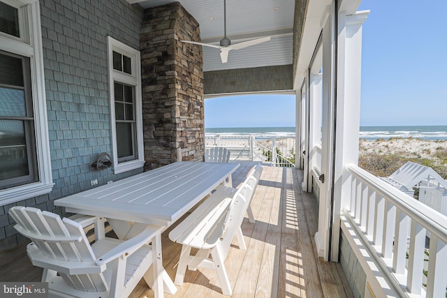 1 103rd St, Stone Harbor, NJ 08247 - wooden deck with outdoor dining space, a beach view, a ceiling fan, and a water view